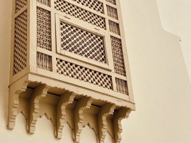 Intricate Mashrabiya wooden lattice screen in modern interior design, blending tradition, light-shadow balance and cultural heritage.