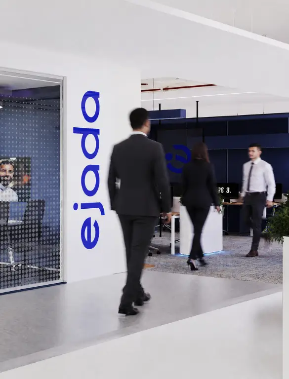 Ejada Cairo office interior with blue branding, glass partitions, and a modern workspace