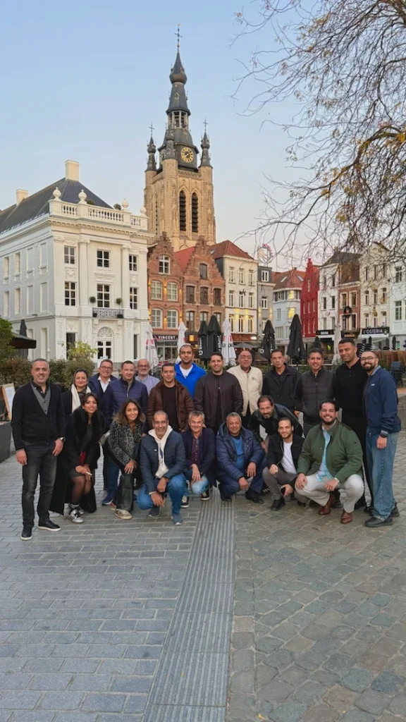 Group of professionals and partners visiting Unilin Panels Headquarters and PERGO Factory, exploring sustainable interior design innovations guided by Elise Taelman and Gino Devolder, showcasing eco-friendly materials, technology, and craftsmanship.