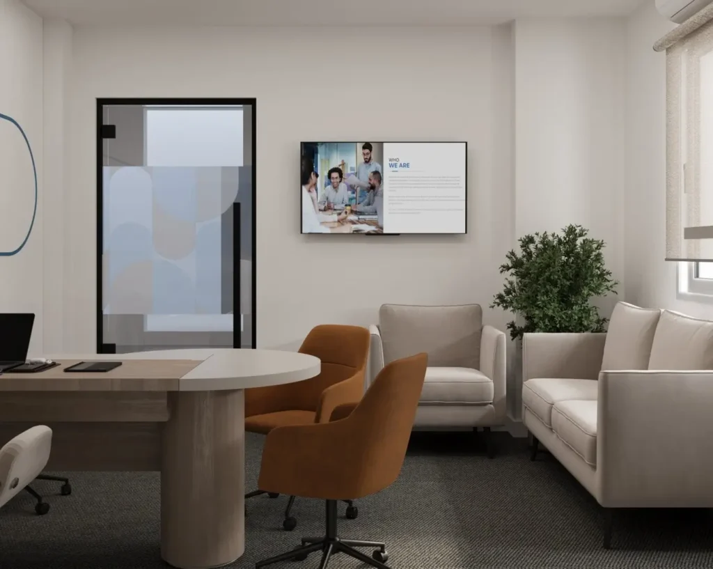 Contemporary office meeting room interior design with sofa seating, round table workspace, glass door, and indoor plants.