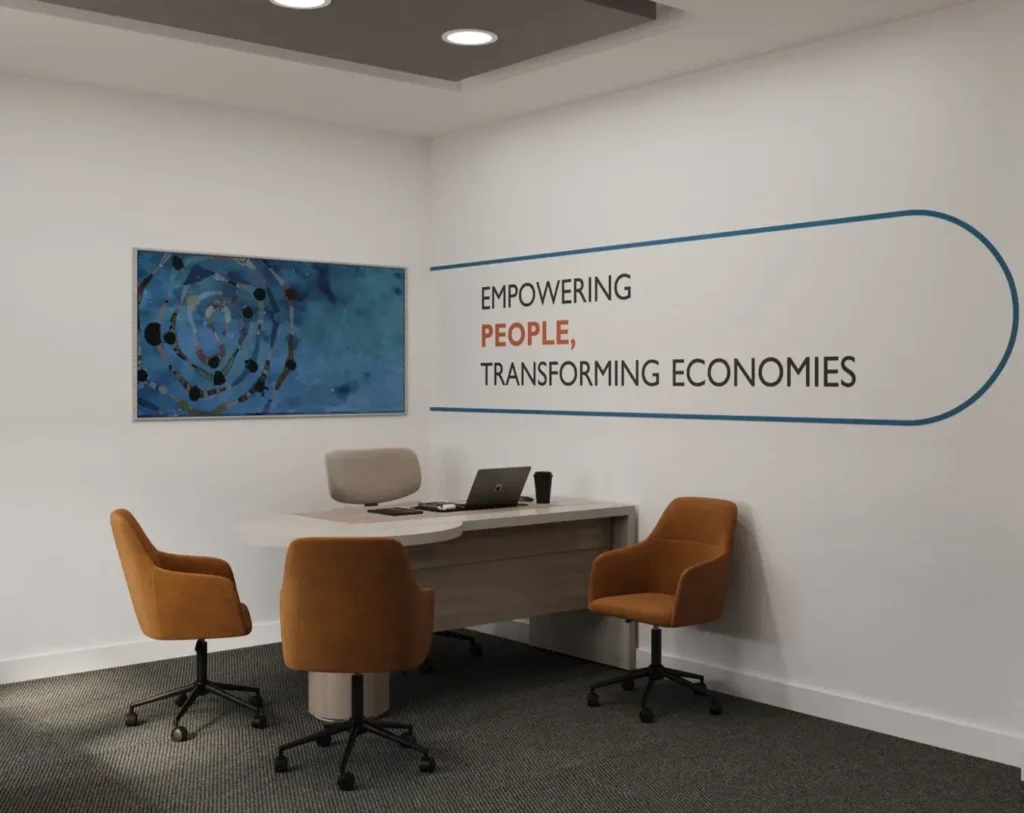 Minimal executive office interior with desk workspace, orange office chairs, wall branding, and modern corporate design.